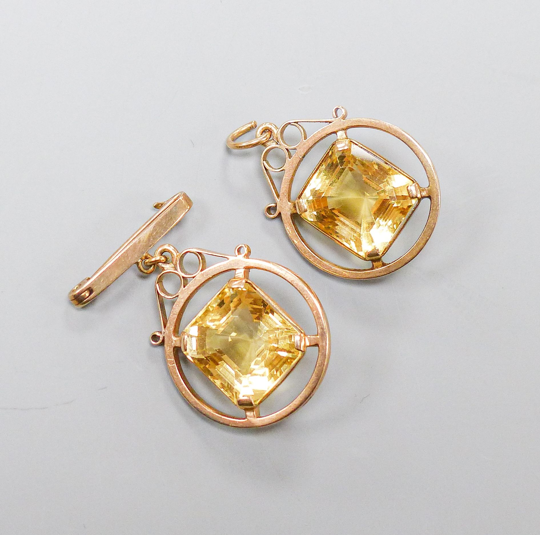 A 9ct mounted step-cut octagonal citrine pendant, 29mm and a matching brooch with suspension pin, gross weight 15.4 grams